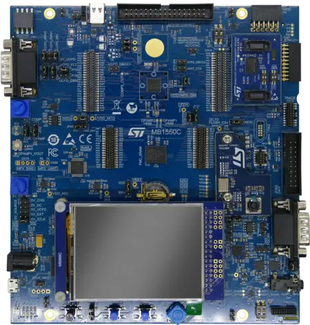 The image depicts a blue electronic circuit board labeled "MB1550C." It features various components, including connectors, microcontroller interfaces, and a blank display area. The layout includes multiple pins and ports for connecting peripherals. The overall design suggests it is intended for development or prototyping purposes.